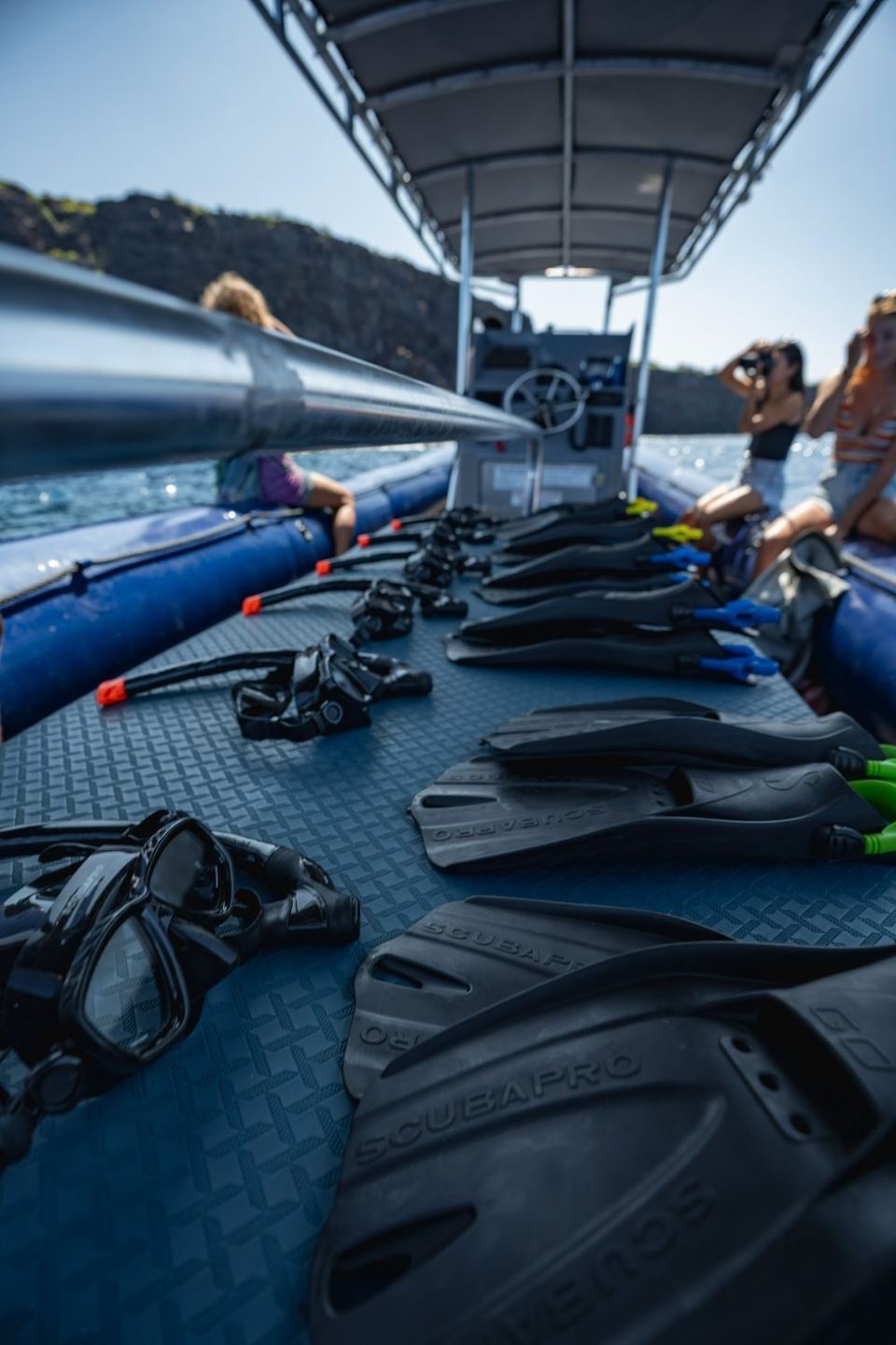 Masks, snorkels and fins laid out on the deck before a reef stop